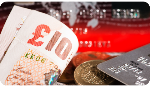 Photo of a £10 note, a credit card and coins in the background
